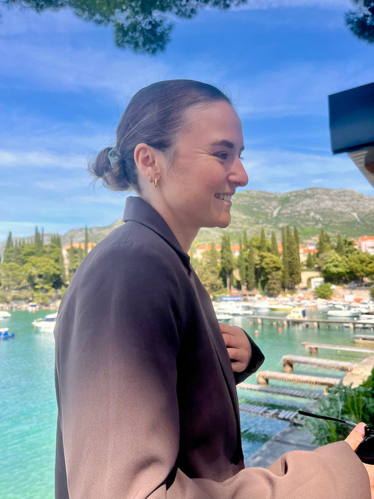 Kirsty Cook smiling beside a harbour