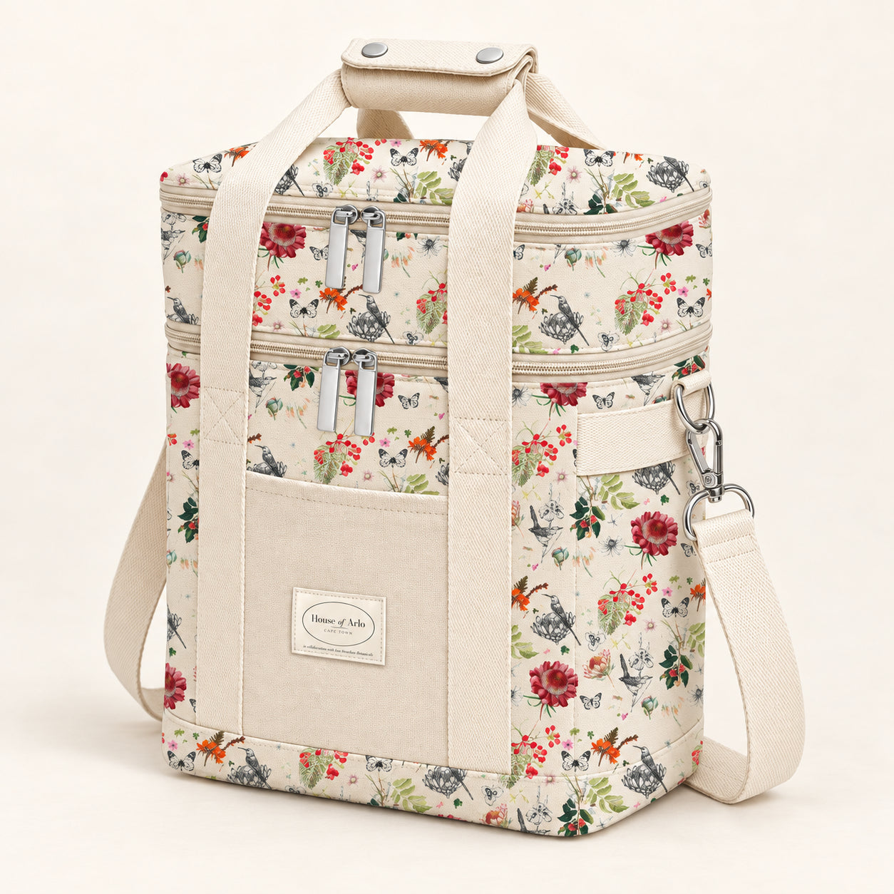 Product mockup of the full-colour botanical picnic cooler bag with two zip compartments, cream handles and front pocket